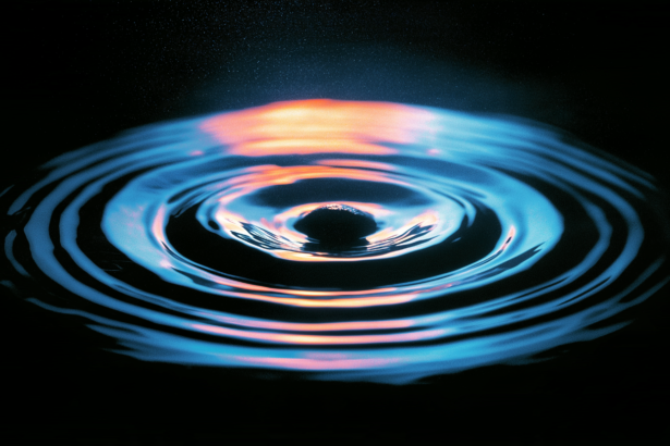 Ripples spreading from a single point, representing a claim travelling outward through repetition