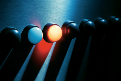 Eight indicator lamps on a metal panel with only two of them lit.