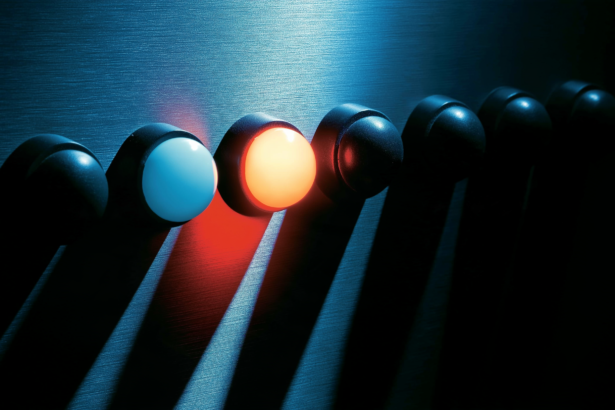 Eight indicator lamps on a metal panel with only two of them lit.