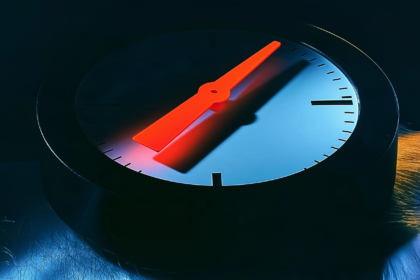 A close up of an analogue gauge needle sitting between two unmarked positions on a dial.